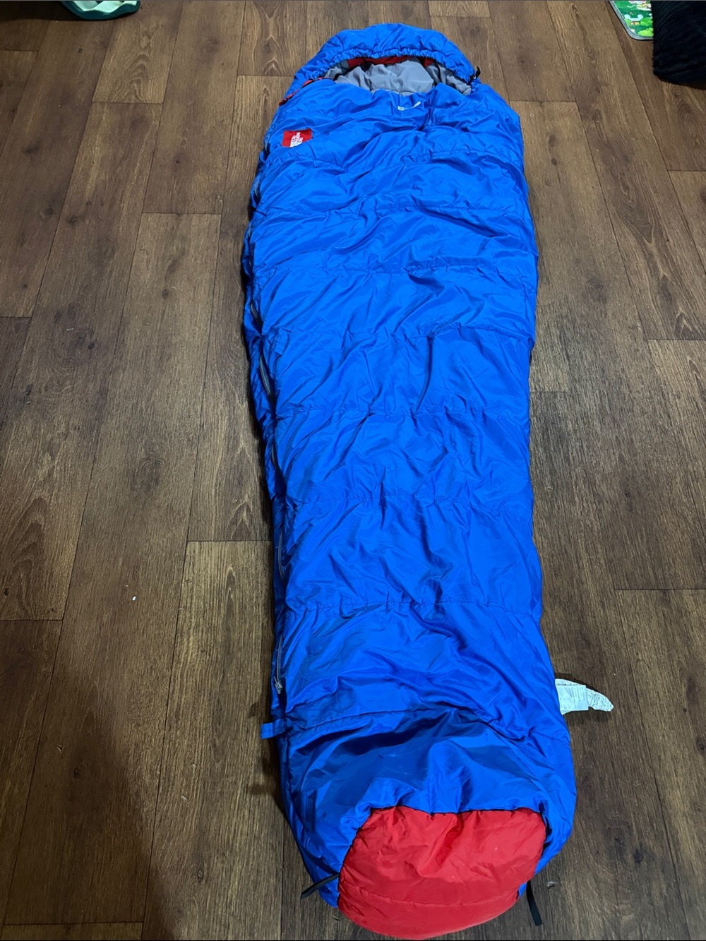 The North Face mummy Blue Sleeping Bag with Red Logo Patch